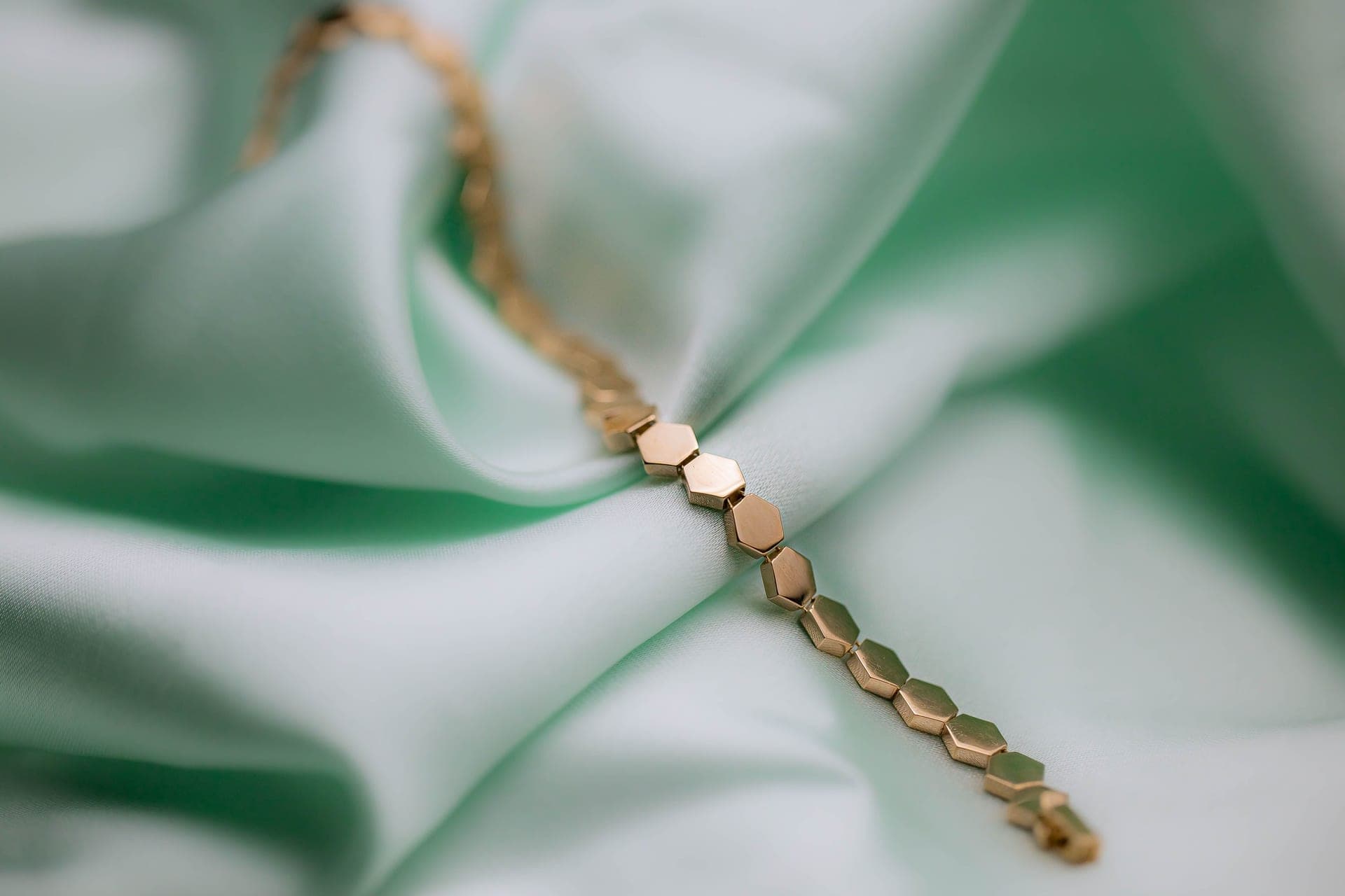 Close-up of gold-toned chain links, showing the surface finish a buyer is trying to judge