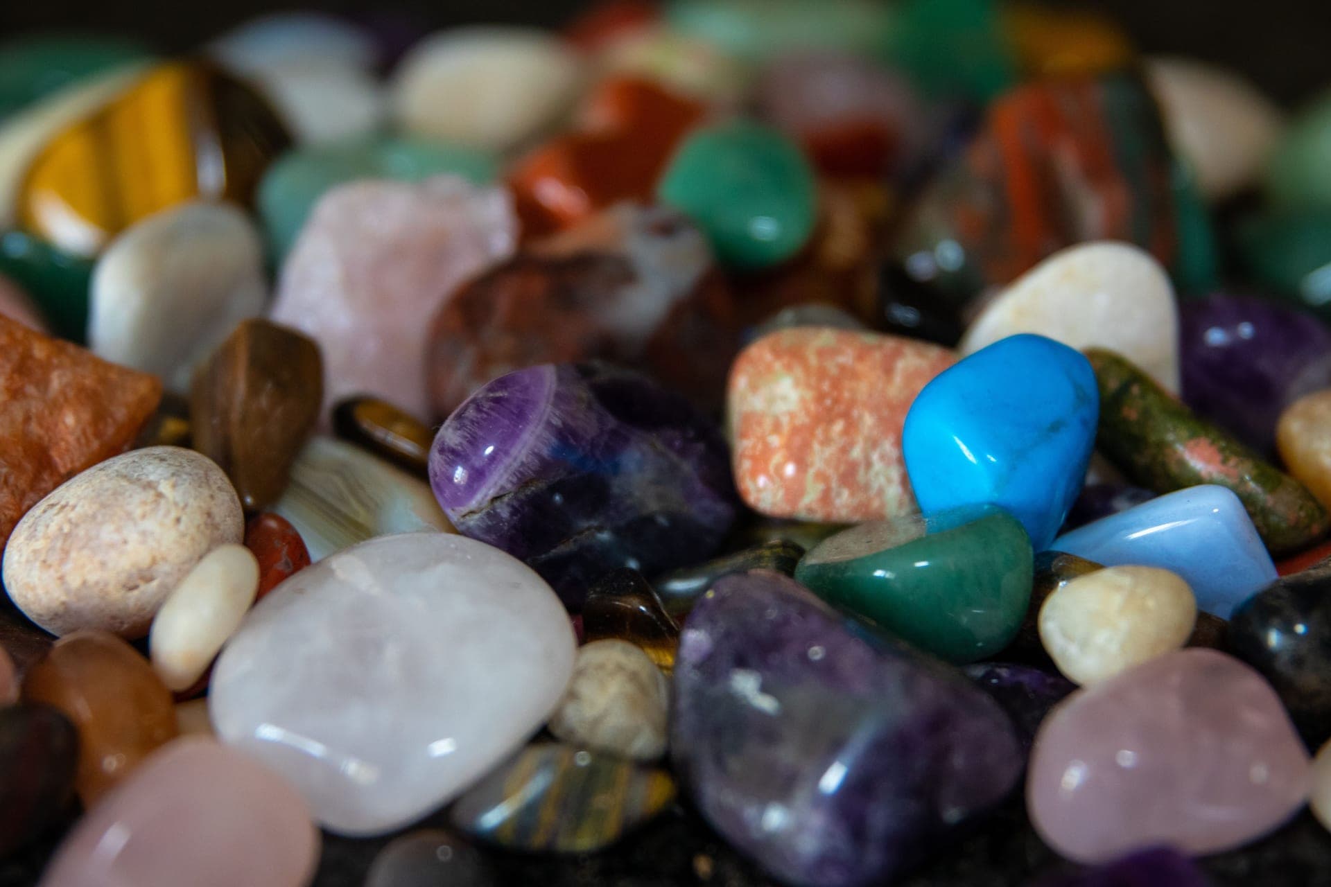 Colored gemstones arranged on a pale background