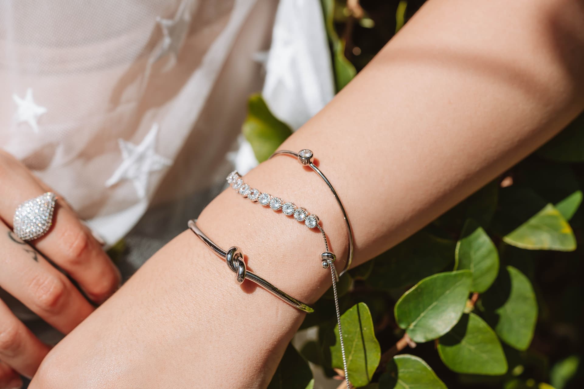 Several bracelets stacked on a wrist