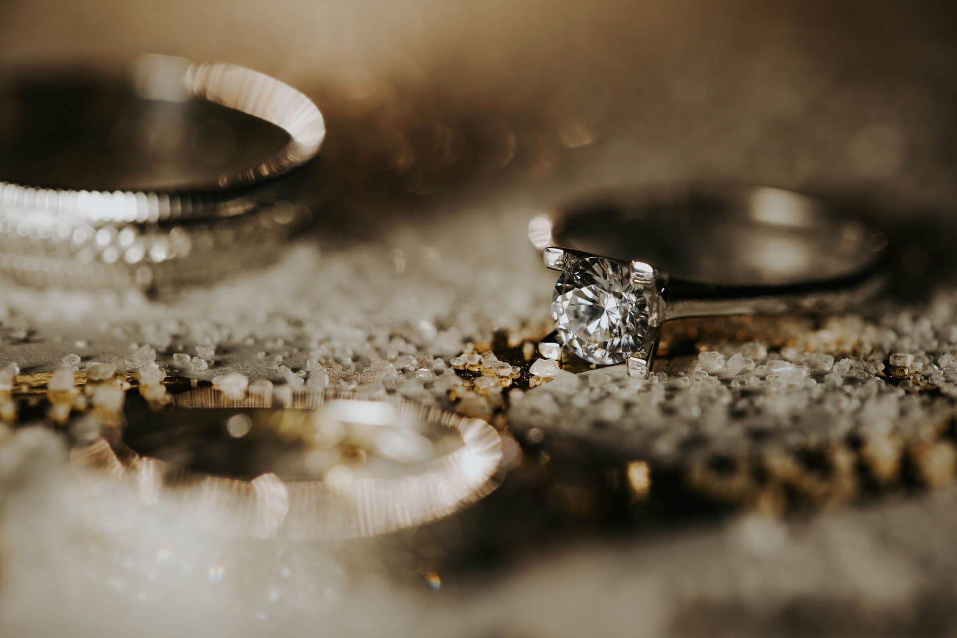 A solitaire ring photographed against a soft background