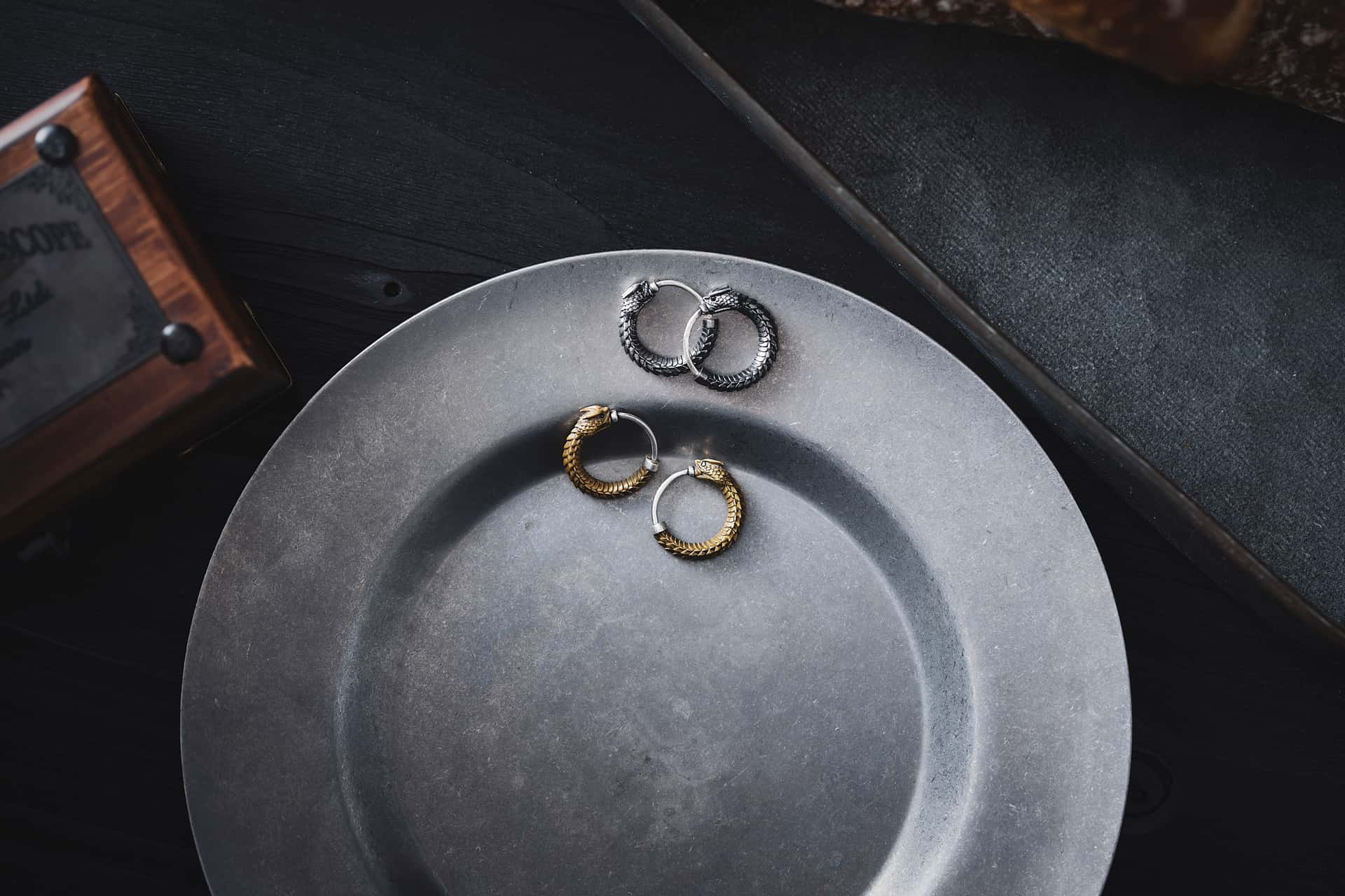 Small gold-toned hoop earrings on a light surface