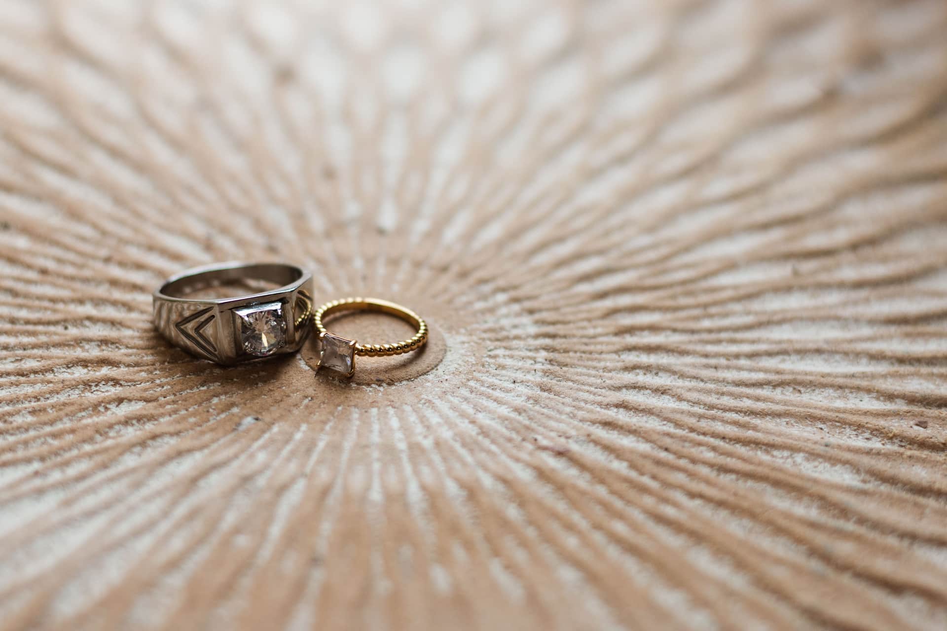 Gold rings and bands arranged on a pale linen surface
