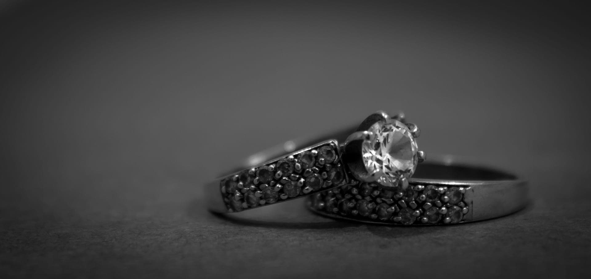 A sparkling faceted gemstone ring catching colored light