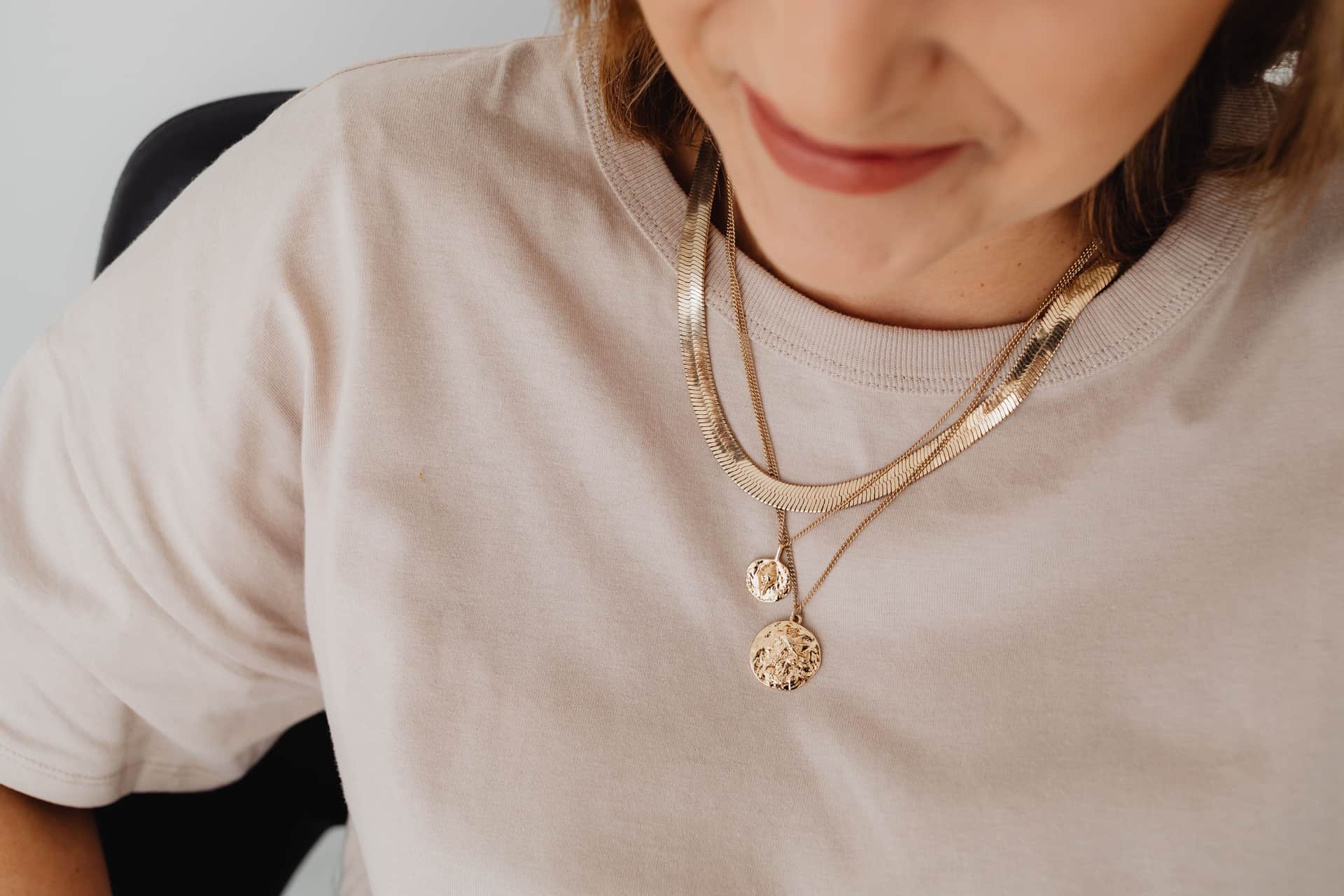 Fine jewelry pieces arranged on a neutral surface